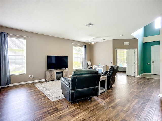 5830 100th Ave E, Parrish, FL 34219 - living room featuring dark wood-type flooring, plenty of natural light, and a ceiling fan