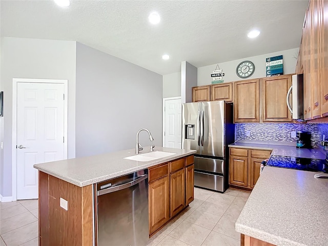 5830 100th Ave E, Parrish, FL 34219 - kitchen with appliances with stainless steel finishes, light tile patterned flooring, a center island with sink, light countertops, and backsplash