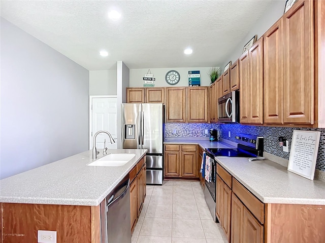 5830 100th Ave E, Parrish, FL 34219 - kitchen with appliances with stainless steel finishes, backsplash, brown cabinets, recessed lighting, and a kitchen island with sink