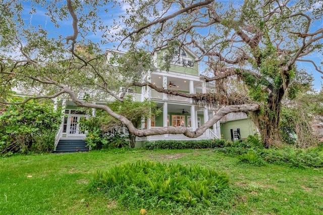 6220 Bayshore Blvd, Tampa, FL 33611 - back of house with ceiling fan, a balcony, and a yard