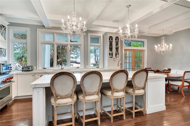 6220 Bayshore Blvd, Tampa, FL 33611 - kitchen featuring a chandelier, stainless steel appliances, dark wood-style flooring, pendant lighting, and coffered ceiling