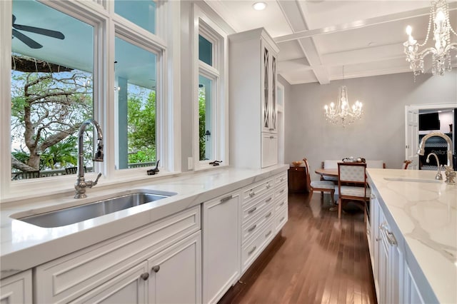 6220 Bayshore Blvd, Tampa, FL 33611 - kitchen with a chandelier, coffered ceiling, beamed ceiling, dark wood finished floors, and light stone counters