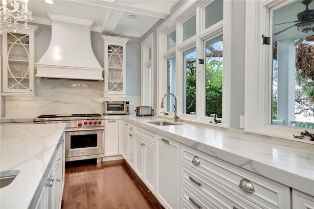 6220 Bayshore Blvd, Tampa, FL 33611 - kitchen with luxury range, premium range hood, healthy amount of natural light, crown molding, and decorative backsplash