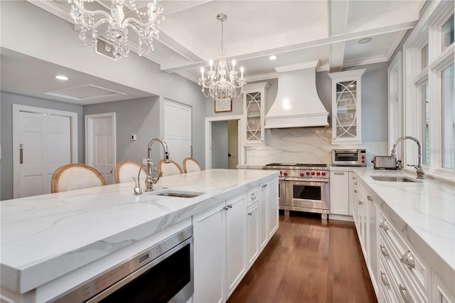 6220 Bayshore Blvd, Tampa, FL 33611 - kitchen featuring appliances with stainless steel finishes, premium range hood, backsplash, coffered ceiling, and white cabinets