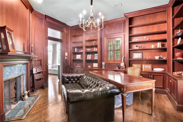 6220 Bayshore Blvd, Tampa, FL 33611 - office with wood finished floors, a premium fireplace, a chandelier, and built in shelves