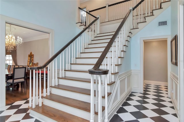 6220 Bayshore Blvd, Tampa, FL 33611 - stairway featuring a chandelier, tile patterned floors, crown molding, and a towering ceiling