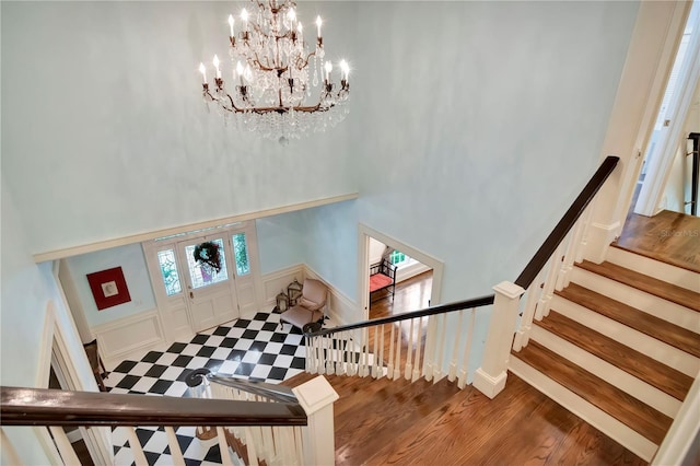 6220 Bayshore Blvd, Tampa, FL 33611 - stairs featuring a high ceiling, a chandelier, wood finished floors, and a decorative wall