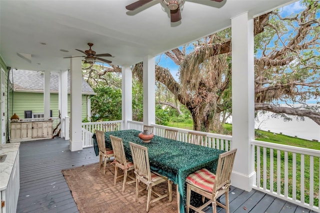 6220 Bayshore Blvd, Tampa, FL 33611 - wooden deck with a ceiling fan and outdoor dining space