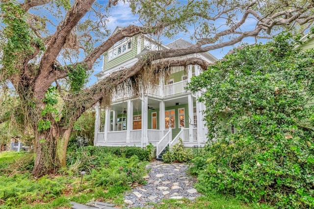 6220 Bayshore Blvd, Tampa, FL 33611 - view of front of home with a ceiling fan, covered porch, a balcony, and stairs