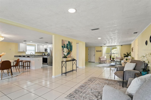 7401 Islander Ln, Hudson, FL 34667 - living room featuring a textured ceiling, light tile patterned floors, and recessed lighting