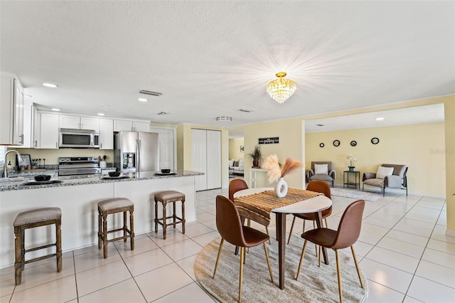 7401 Islander Ln, Hudson, FL 34667 - dining space with light tile patterned floors and a chandelier