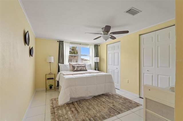 7401 Islander Ln, Hudson, FL 34667 - bedroom with light tile patterned flooring, crown molding, two closets, and a ceiling fan