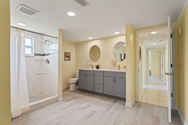 7401 Islander Ln, Hudson, FL 34667 - bathroom with double vanity, a tile shower, and recessed lighting