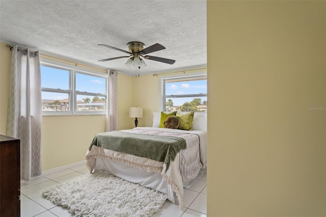 7401 Islander Ln, Hudson, FL 34667 - bedroom featuring light tile patterned floors, a textured ceiling, and ceiling fan