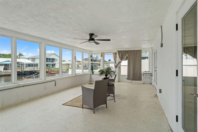 7401 Islander Ln, Hudson, FL 34667 - sunroom / solarium with a water view, ceiling fan, a textured ceiling, and speckle patterned floor