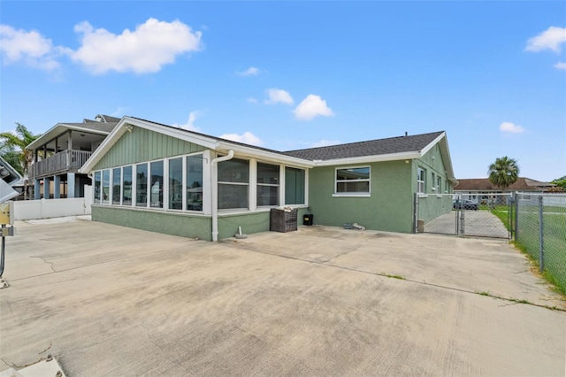 7401 Islander Ln, Hudson, FL 34667 - rear view of house with a gate and stucco siding