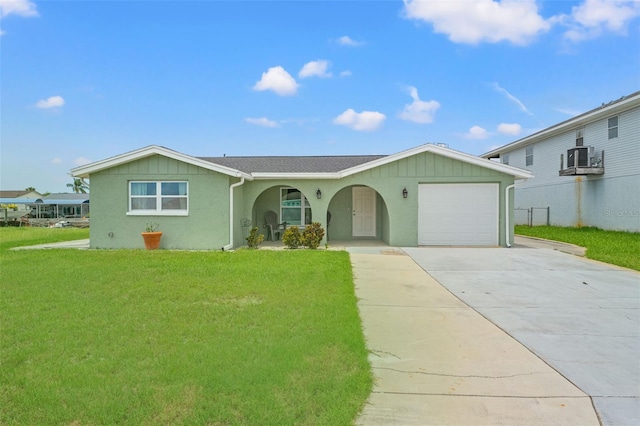 7401 Islander Ln, Hudson, FL 34667 - ranch-style home with concrete driveway, a front yard, a garage, stucco siding, and covered porch