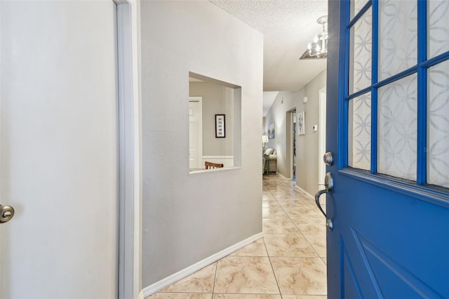 4108 Woodtrail Blvd, New Port Richey, FL 34653 - tiled foyer entrance with a textured ceiling and a chandelier