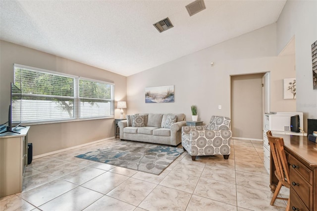 4108 Woodtrail Blvd, New Port Richey, FL 34653 - living area with lofted ceiling, light tile patterned floors, and a textured ceiling