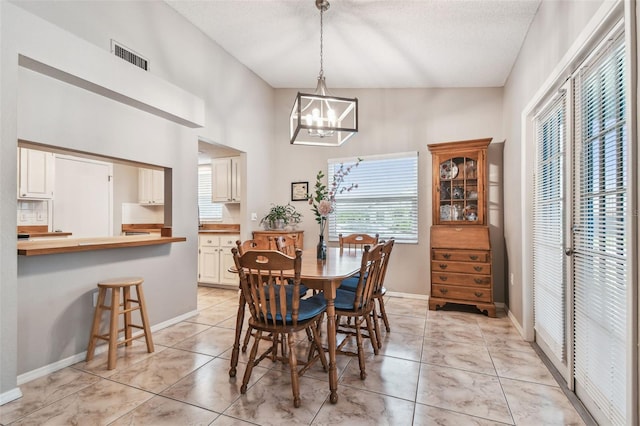 4108 Woodtrail Blvd, New Port Richey, FL 34653 - dining space with a chandelier and a textured ceiling