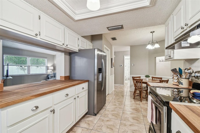 4108 Woodtrail Blvd, New Port Richey, FL 34653 - kitchen with wooden counters, stainless steel appliances, under cabinet range hood, white cabinets, and a chandelier