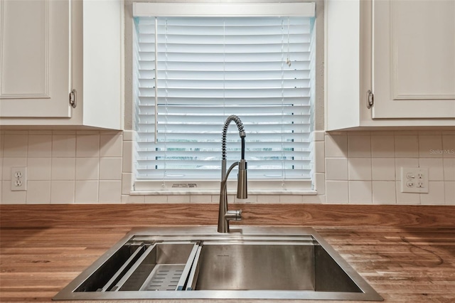 4108 Woodtrail Blvd, New Port Richey, FL 34653 - kitchen view of tasteful backsplash and white cabinets