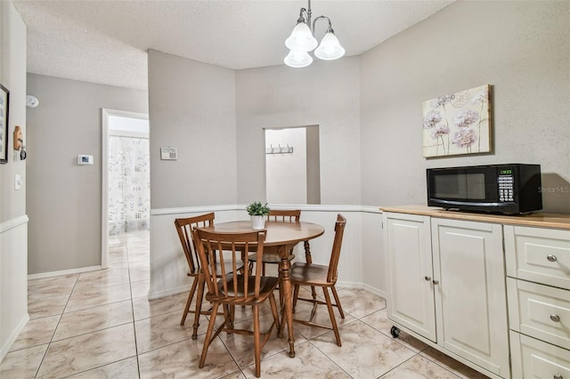 4108 Woodtrail Blvd, New Port Richey, FL 34653 - dining room featuring a chandelier, a textured ceiling, and light tile patterned floors