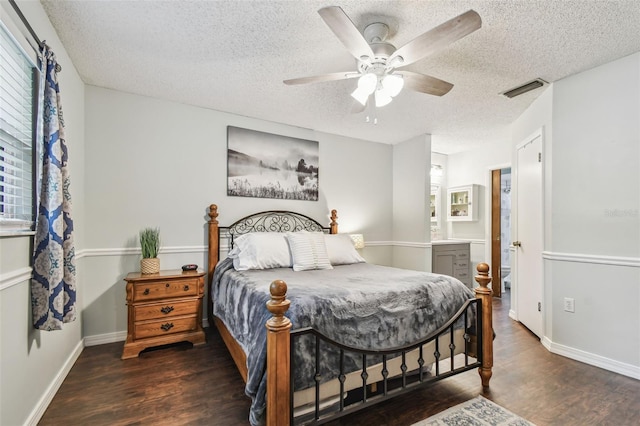 4108 Woodtrail Blvd, New Port Richey, FL 34653 - bedroom featuring wood finished floors, a textured ceiling, a ceiling fan, and ensuite bath