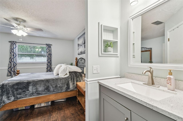 4108 Woodtrail Blvd, New Port Richey, FL 34653 - bedroom featuring dark wood-type flooring, a textured ceiling, and ceiling fan