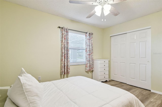 4108 Woodtrail Blvd, New Port Richey, FL 34653 - bedroom with wood finished floors, a closet, a ceiling fan, and a textured ceiling
