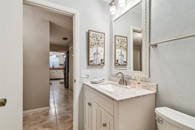 4108 Woodtrail Blvd, New Port Richey, FL 34653 - bathroom featuring vanity, tile patterned flooring, and a textured wall