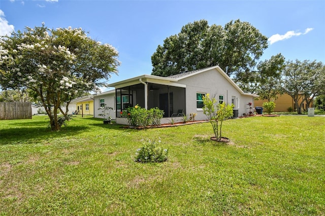 4108 Woodtrail Blvd, New Port Richey, FL 34653 - back of house with a sunroom and stucco siding