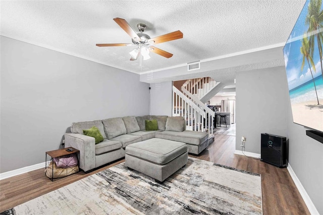 3350 Fox Hunt Dr, Palm Harbor, FL 34683 - living room featuring stairway, a textured ceiling, wood finished floors, and a ceiling fan