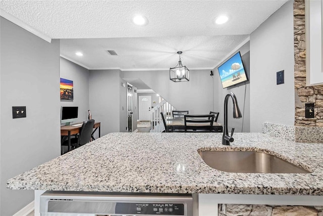 3350 Fox Hunt Dr, Palm Harbor, FL 34683 - kitchen with dishwasher, a textured ceiling, ornamental molding, light stone counters, and a chandelier