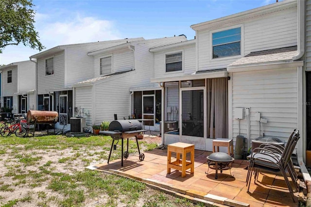 3350 Fox Hunt Dr, Palm Harbor, FL 34683 - rear view of house with a fire pit, a sunroom, and a patio area