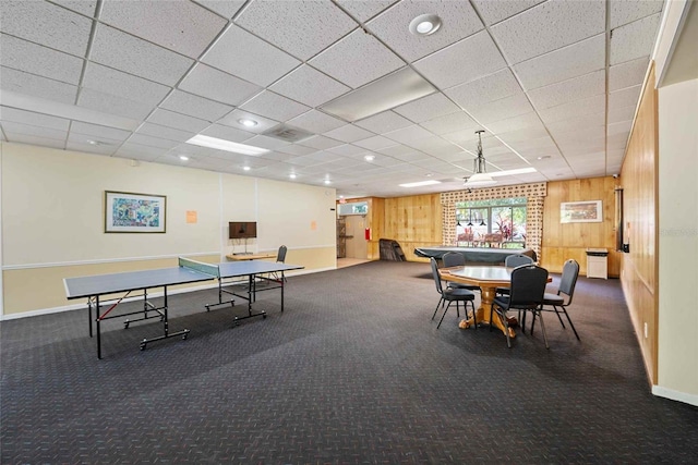 3350 Fox Hunt Dr, Palm Harbor, FL 34683 - recreation room featuring wooden walls, carpet, a paneled ceiling, and a ceiling fan
