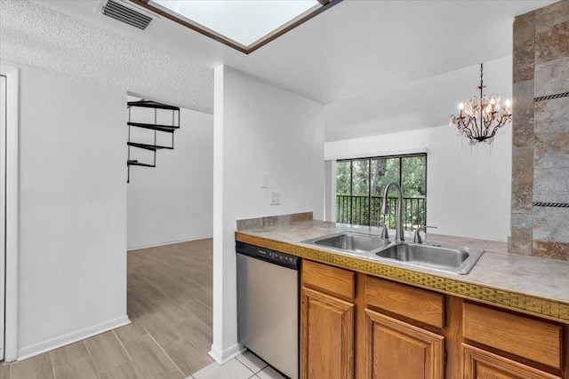 7811 Niagara Ave Unit 2125, Tampa, FL 33617 - kitchen with stainless steel dishwasher, brown cabinetry, a chandelier, light countertops, and decorative light fixtures