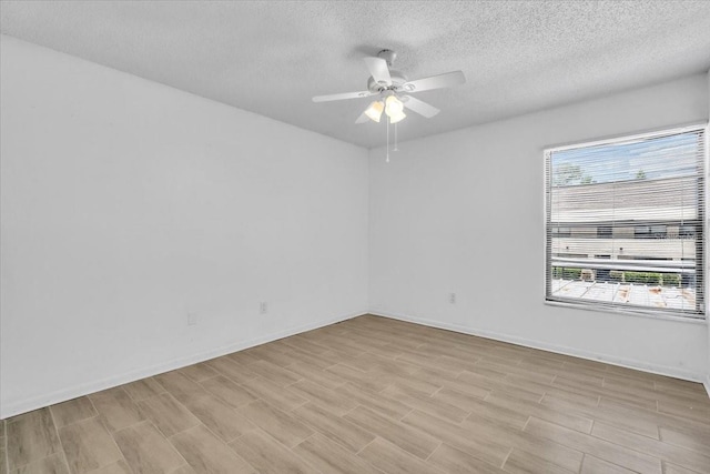 7811 Niagara Ave Unit 2125, Tampa, FL 33617 - unfurnished room with a ceiling fan, a textured ceiling, and light wood-style flooring