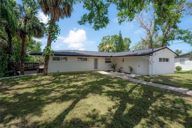 6108 Oak Ridge Ave, New Port Richey, FL 34653 - ranch-style home with stucco siding, a deck, and a front yard