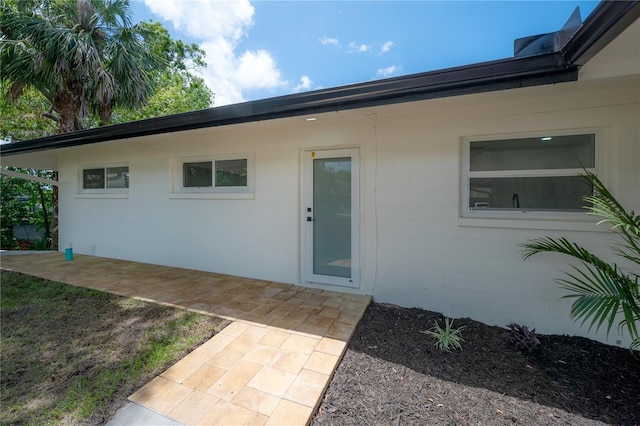 6108 Oak Ridge Ave, New Port Richey, FL 34653 - view of exterior entry featuring concrete block siding and a patio