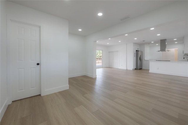 6108 Oak Ridge Ave, New Port Richey, FL 34653 - unfurnished living room featuring light wood-style flooring and recessed lighting