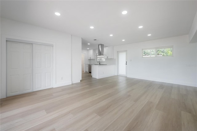 6108 Oak Ridge Ave, New Port Richey, FL 34653 - unfurnished living room featuring light wood-style flooring and recessed lighting