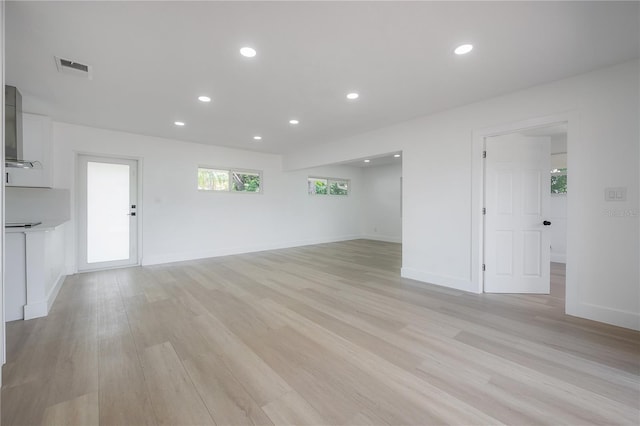 6108 Oak Ridge Ave, New Port Richey, FL 34653 - unfurnished living room featuring light wood-style floors and recessed lighting