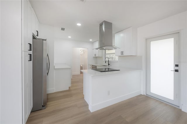 6108 Oak Ridge Ave, New Port Richey, FL 34653 - kitchen featuring freestanding refrigerator, ventilation hood, light wood-style floors, light countertops, and recessed lighting