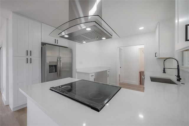 6108 Oak Ridge Ave, New Port Richey, FL 34653 - kitchen with stainless steel fridge with ice dispenser, island range hood, stovetop, white cabinetry, and light countertops