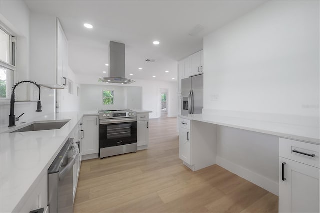 6108 Oak Ridge Ave, New Port Richey, FL 34653 - kitchen with appliances with stainless steel finishes, island range hood, white cabinetry, a peninsula, and recessed lighting