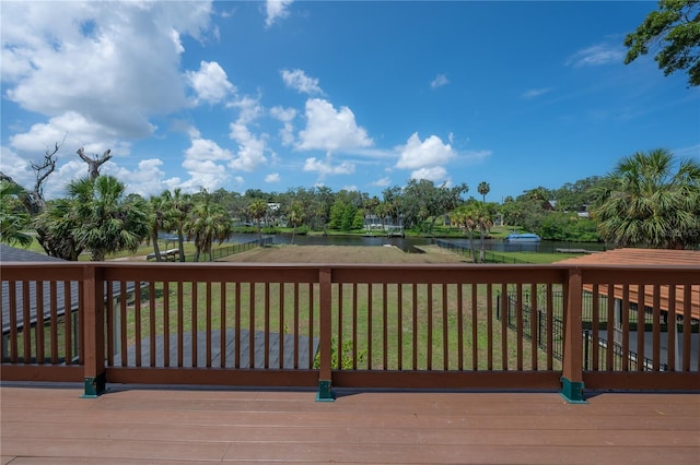 6108 Oak Ridge Ave, New Port Richey, FL 34653 - wooden deck featuring a water view, a lawn, and view of wooded area