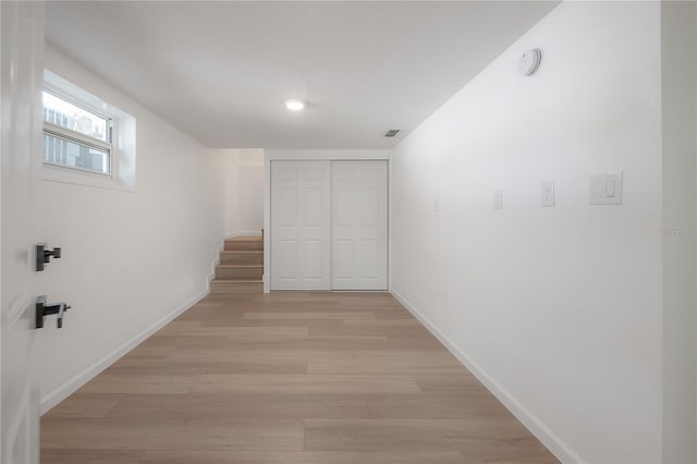 6108 Oak Ridge Ave, New Port Richey, FL 34653 - corridor with stairway and light wood-style floors
