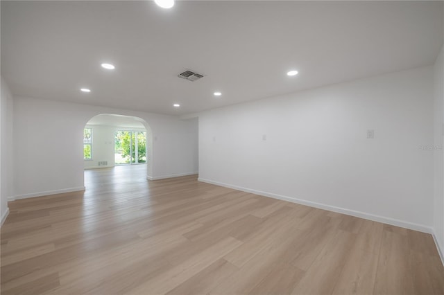 6108 Oak Ridge Ave, New Port Richey, FL 34653 - unfurnished room featuring arched walkways, light wood-type flooring, and recessed lighting