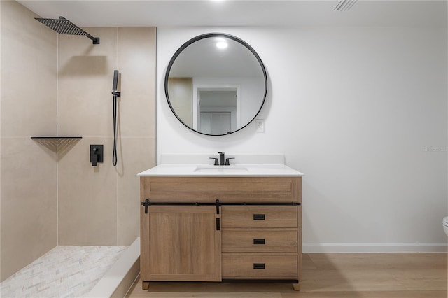 6108 Oak Ridge Ave, New Port Richey, FL 34653 - full bathroom featuring a tile shower, vanity, and wood finished floors